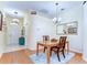 Traditional dining room featuring wood floors, chandelier and decorative mirror at 4503 Lace Cascade Ct, Lutz, FL 33558