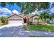 Charming single-story home with a well-manicured lawn and a two-car garage at 4503 Lace Cascade Ct, Lutz, FL 33558