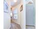 Hallway view showcasing neutral paint, carpet, and a decorative door at 4503 Lace Cascade Ct, Lutz, FL 33558