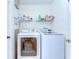 Efficient laundry room with a full size, front load washer and dryer and ample shelving for storage at 4503 Lace Cascade Ct, Lutz, FL 33558
