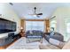 Comfortable living room with a ceiling fan, neutral paint and a large window at 4503 Lace Cascade Ct, Lutz, FL 33558