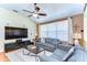Cozy living room featuring a vaulted ceiling, large windows, and neutral colored furniture at 4503 Lace Cascade Ct, Lutz, FL 33558