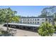 Well-maintained three-story condo building with covered parking and lush landscaping at 4801 Airport Rd # 214, Zephyrhills, FL 33542