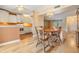 Charming dining area with hardwood floors, a chandelier, and views into the adjacent kitchen at 4801 Airport Rd # 214, Zephyrhills, FL 33542