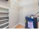 Utility room features water heater, shelving and hardwood floors at 4801 Airport Rd # 214, Zephyrhills, FL 33542