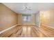 Bright living room featuring hardwood floors and a window with stylish valances at 4801 Airport Rd # 214, Zephyrhills, FL 33542