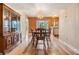 Cozy dining room featuring hardwood floors, a crystal chandelier, and views into the kitchen at 4801 Airport Rd # 214, Zephyrhills, FL 33542