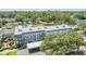 Wide aerial shot of condo community featuring a pool, landscaping, and ample parking at 4801 Airport Rd # 214, Zephyrhills, FL 33542