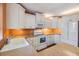 Bright kitchen with white cabinets, modern appliances, and ample countertop space at 4801 Airport Rd # 214, Zephyrhills, FL 33542
