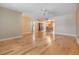 Open living room features hardwood floors, a ceiling fan, and flows into the dining room at 4801 Airport Rd # 214, Zephyrhills, FL 33542