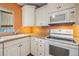 Bright kitchen featuring white cabinets and modern appliances at 4801 Airport Rd # 214, Zephyrhills, FL 33542