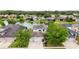 Aerial view of a two-story home with lake view at 4810 Diamonds Palm Loop, Wesley Chapel, FL 33543