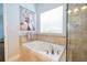 Bathroom with a soaking tub and a large window, offering plenty of natural light at 4810 Diamonds Palm Loop, Wesley Chapel, FL 33543