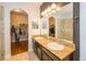 Bathroom featuring double sinks, granite counters, and separate shower and closet rooms at 4810 Diamonds Palm Loop, Wesley Chapel, FL 33543