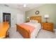 Cozy bedroom with a comfortable bed, featuring two bedside lamps and an overhead ceiling fan at 4810 Diamonds Palm Loop, Wesley Chapel, FL 33543