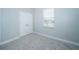 Cozy bedroom with a window that brings in natural light, carpeted floors and a double door closet at 4810 Diamonds Palm Loop, Wesley Chapel, FL 33543