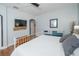 Bedroom featuring hardwood floors, light-colored walls, and a large bed with decorative pillows at 4810 Diamonds Palm Loop, Wesley Chapel, FL 33543