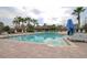 Inviting community pool with palm trees and lounge chairs, perfect for relaxation at 4810 Diamonds Palm Loop, Wesley Chapel, FL 33543