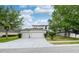 Charming two-story home with a three-car garage and well-maintained front yard at 4810 Diamonds Palm Loop, Wesley Chapel, FL 33543