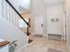 Bright foyer with staircase, tile flooring, neutral walls, and bench seating at 4810 Diamonds Palm Loop, Wesley Chapel, FL 33543