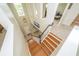 Bright foyer with wood stairs, a pendant light, and a view of the living room at 4810 Diamonds Palm Loop, Wesley Chapel, FL 33543