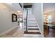 Spacious hallway area with stairs to the second floor, and views into other rooms at 4810 Diamonds Palm Loop, Wesley Chapel, FL 33543
