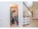 Hallway area featuring a small storage room on the left and a staircase to the right at 4810 Diamonds Palm Loop, Wesley Chapel, FL 33543
