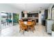 Open kitchen and dining area with dark cabinetry and granite counters, plus outdoor access to a patio at 4810 Diamonds Palm Loop, Wesley Chapel, FL 33543