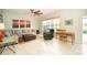Bright living room featuring a gray sectional sofa, ceiling fan, and decoratively designed area rug at 4810 Diamonds Palm Loop, Wesley Chapel, FL 33543