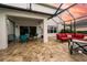 The covered patio features an outdoor dining set and comfortable lounge seating at 4810 Diamonds Palm Loop, Wesley Chapel, FL 33543