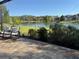 Enjoy the beautiful lake view from this gorgeous brick patio with rocking chairs and lush landscaping at 4810 Diamonds Palm Loop, Wesley Chapel, FL 33543