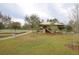 Community playground featuring a shaded play structure, swings, and open green space for outdoor fun and recreation at 4810 Diamonds Palm Loop, Wesley Chapel, FL 33543