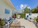 Inviting backyard with patio, grill, seating, manicured lawn, and lush landscaping at 525 Manns Harbor Dr, Apollo Beach, FL 33572