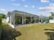 Well-manicured backyard with a screened-in patio and ample green space at 525 Manns Harbor Dr, Apollo Beach, FL 33572