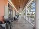 Large balcony with tables, chairs, ceiling fans, and beautiful views of tropical trees at 525 Manns Harbor Dr, Apollo Beach, FL 33572