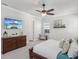 Comfortable bedroom featuring a ceiling fan, dresser, mounted television, and artwork at 525 Manns Harbor Dr, Apollo Beach, FL 33572