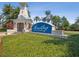 Well-maintained community entrance sign with mature landscaping, tower, and blue skies at 525 Manns Harbor Dr, Apollo Beach, FL 33572
