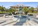 Community fountain with tropical plants with a large, peach building in the background at 525 Manns Harbor Dr, Apollo Beach, FL 33572