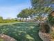 Spacious dog park with lush green turf, mature trees for shade, and comfortable seating at 525 Manns Harbor Dr, Apollo Beach, FL 33572