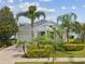 Charming single-story home featuring a manicured lawn, lush tropical landscaping, and a welcoming front porch at 525 Manns Harbor Dr, Apollo Beach, FL 33572
