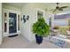 A cozy front porch featuring stylish outdoor furniture and decor, creating a welcoming entrance to the home at 525 Manns Harbor Dr, Apollo Beach, FL 33572