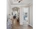 Hallway featuring decorative lighting, arched doorways, and tile flooring leading to other areas of the home at 525 Manns Harbor Dr, Apollo Beach, FL 33572
