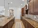Kitchen boasts stainless steel appliances, a gas stove, tile backsplash, granite countertops and an island with a sink at 525 Manns Harbor Dr, Apollo Beach, FL 33572