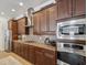 A kitchen is shown with stainless steel appliances, granite countertops, wood cabinets, and a range hood at 525 Manns Harbor Dr, Apollo Beach, FL 33572