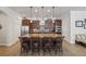 Spacious kitchen features a large island, granite countertops, stainless steel appliances, and dark wood cabinetry at 525 Manns Harbor Dr, Apollo Beach, FL 33572