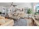 Comfortable living room with ample natural light, casual seating, decor and a ceiling fan at 525 Manns Harbor Dr, Apollo Beach, FL 33572