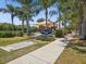 Community playground shaded by a canopy, featuring slides and climbing structures, located near the Wolf Creek Park sign at 525 Manns Harbor Dr, Apollo Beach, FL 33572