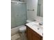 Well-lit bathroom with a shower-tub combo, white fixtures, and a wood-finish vanity at 5967 Terrace Park N Dr # 204, St Petersburg, FL 33709