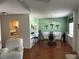 Open dining room featuring a glass-top table, light green walls, and view to the kitchen area at 5967 Terrace Park N Dr # 204, St Petersburg, FL 33709