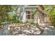 Inviting backyard featuring a wooden deck surrounded by lush greenery and mature trees, perfect for outdoor entertaining at 6014 Luana S Ln, Gulfport, FL 33707